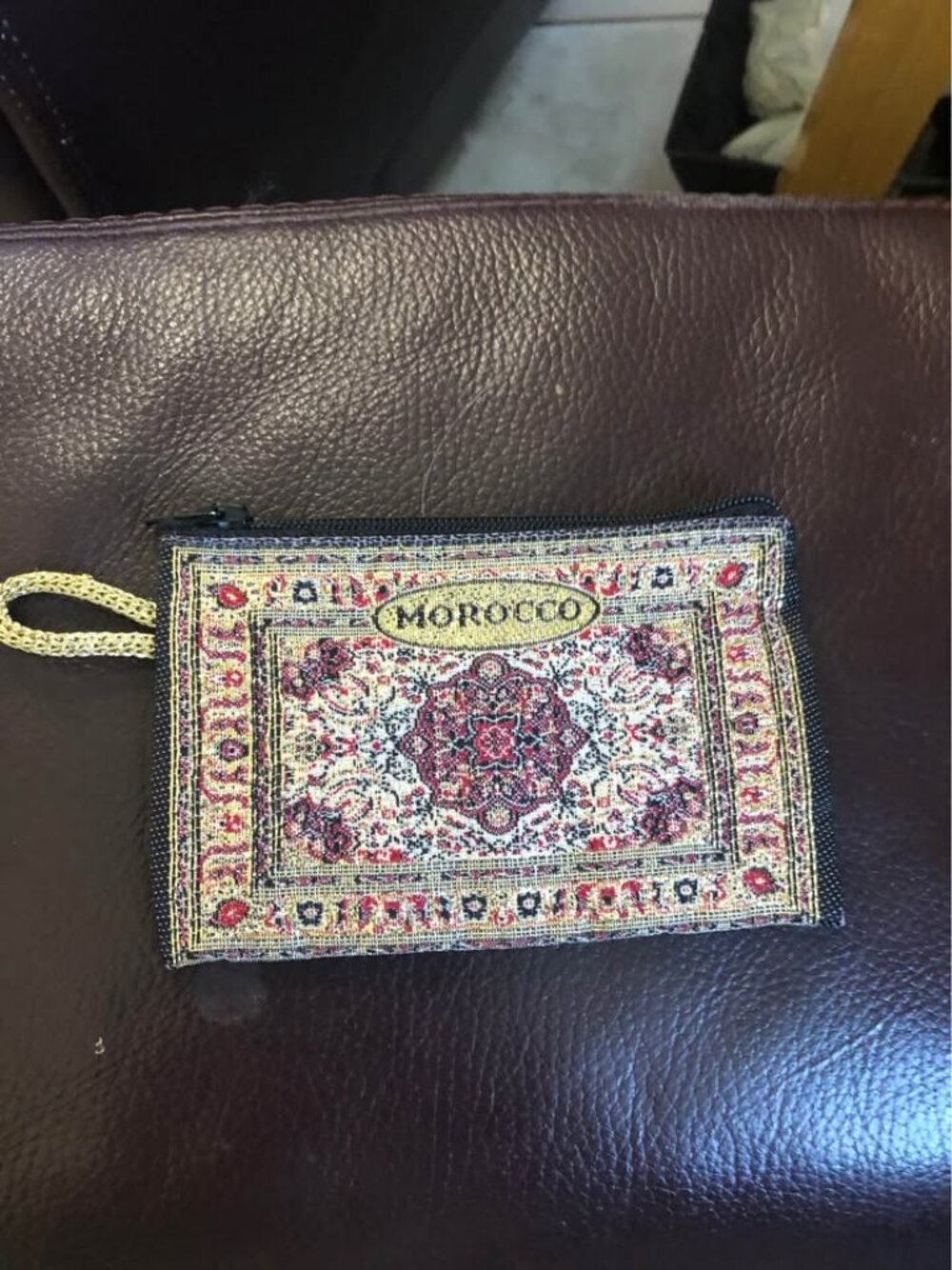 Moroccan tapestry coin purse featuring a woven oriental rug pattern with a centr